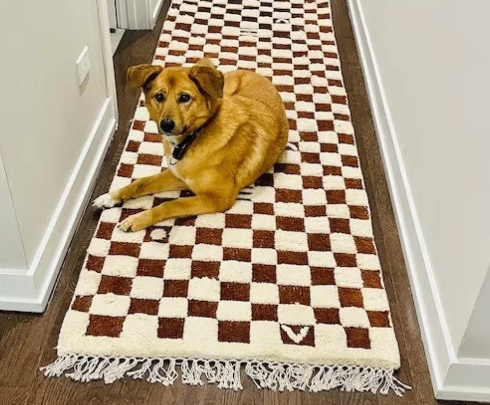 This rustic brown and cream checkered rug brings warmth and charm to any living room, complementing neutral and wooden decor effortlessly.