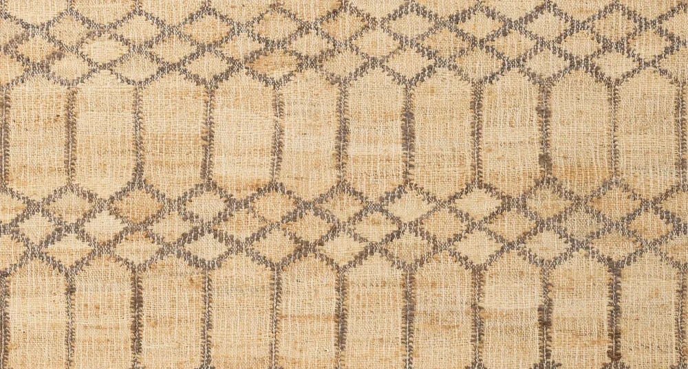 Handwoven rug with warm earthy tones, crafted from natural fibers to create a cozy, organic, and sustainable home ambiance.