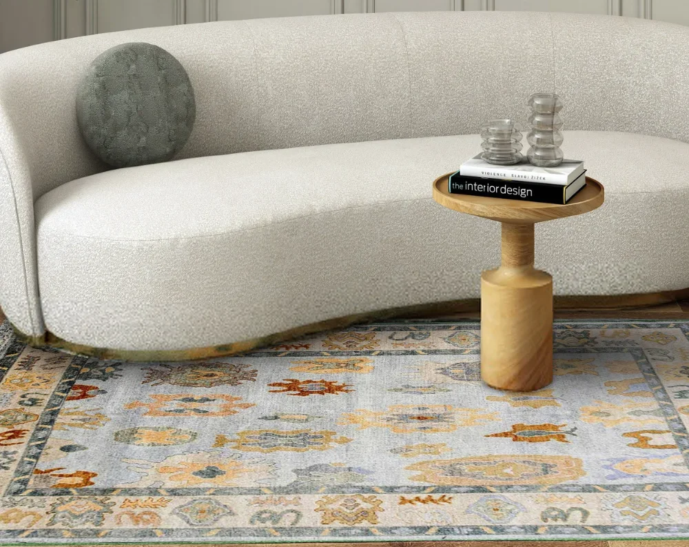 Pastel beige Oushak rug with multicolor floral motifs in a stylish and cozy space.