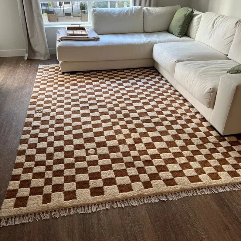 Brown and cream checkered rug in a cozy living room with a white sectional sofa and natural lighting.